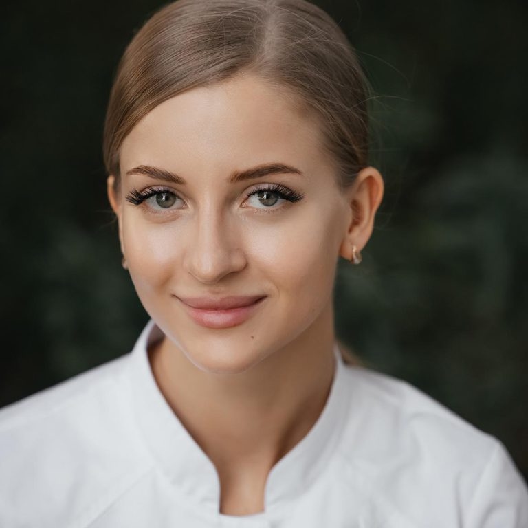 Smiling confident female doctor with lab coat on standing. Practician woman wearing white hospital uniform. Waist up portrait of young cosmetologist . . High quality photo
